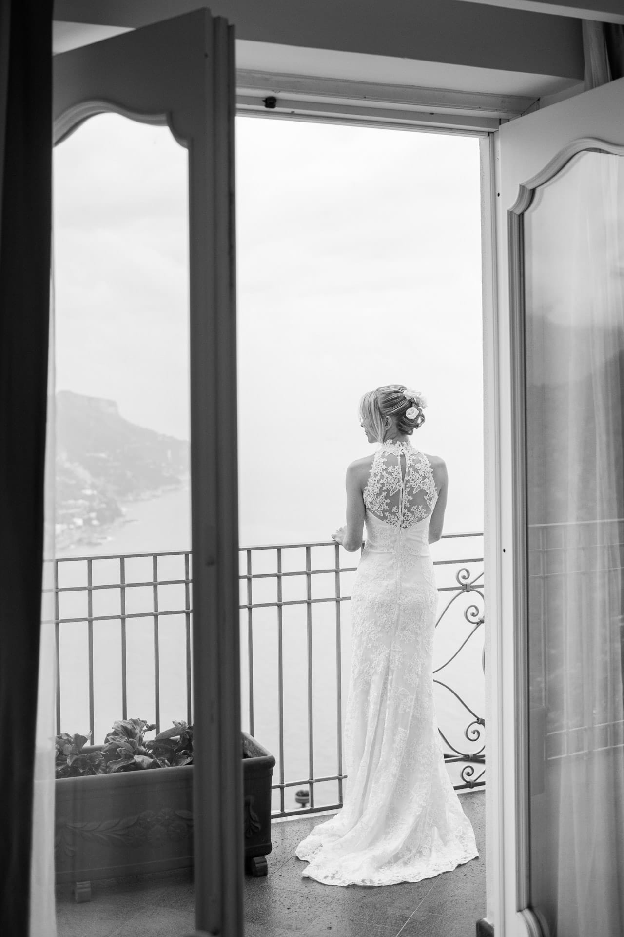 wedding bride looking out on Amalfi from balcony