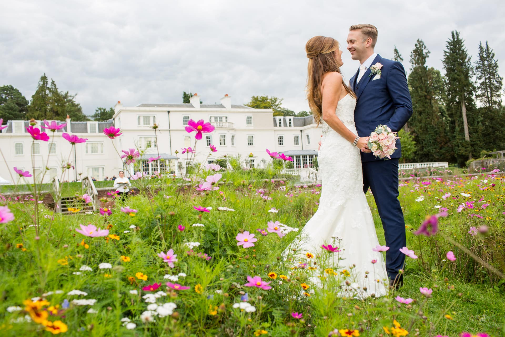 tall bride and groom in the meadow at Coworth