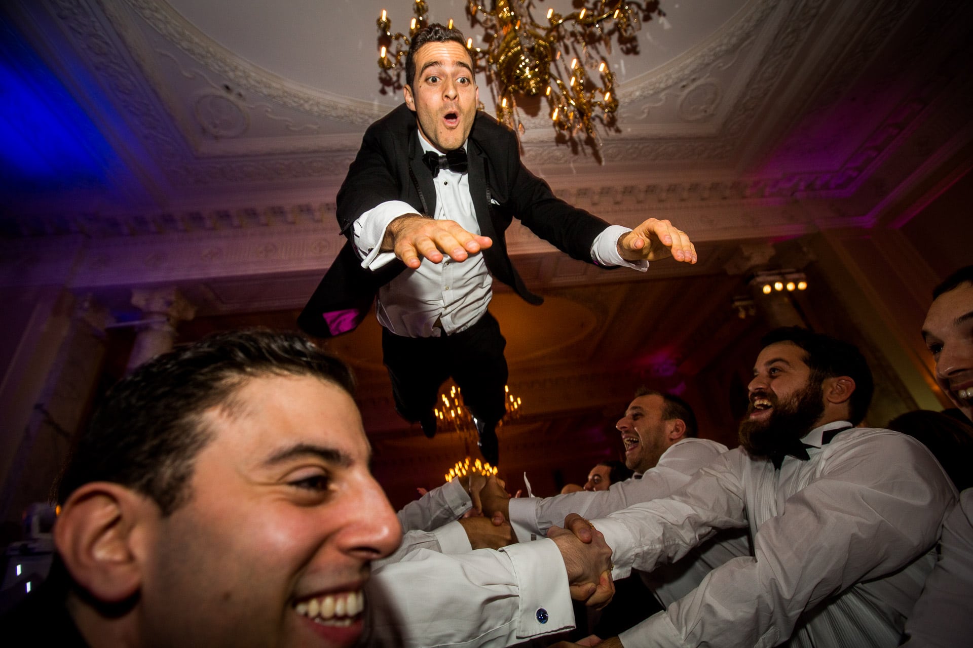 jewish groom flying in the air during Israeli dancing