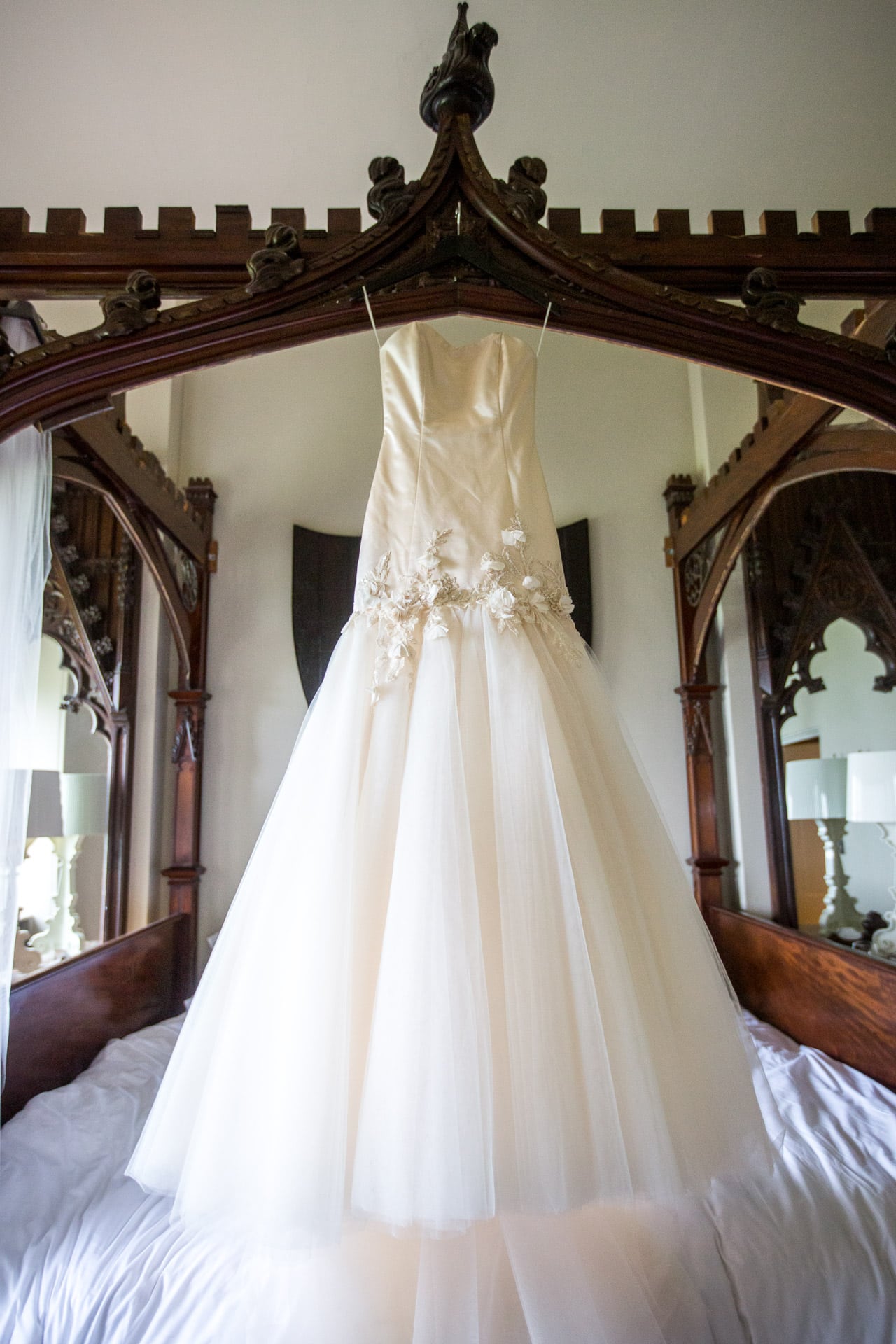 stunning wedding dress hanging in Aynhoe Park bridal suite