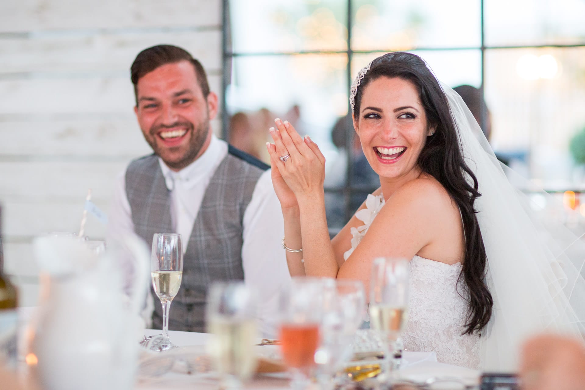 bride laughing at a speech