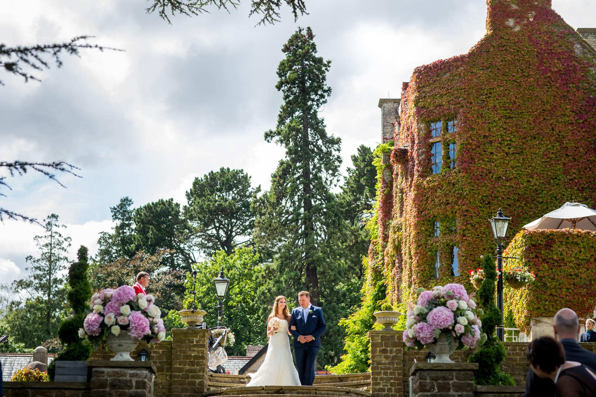 Bride and her Dad walking outside at Pennyhill Park