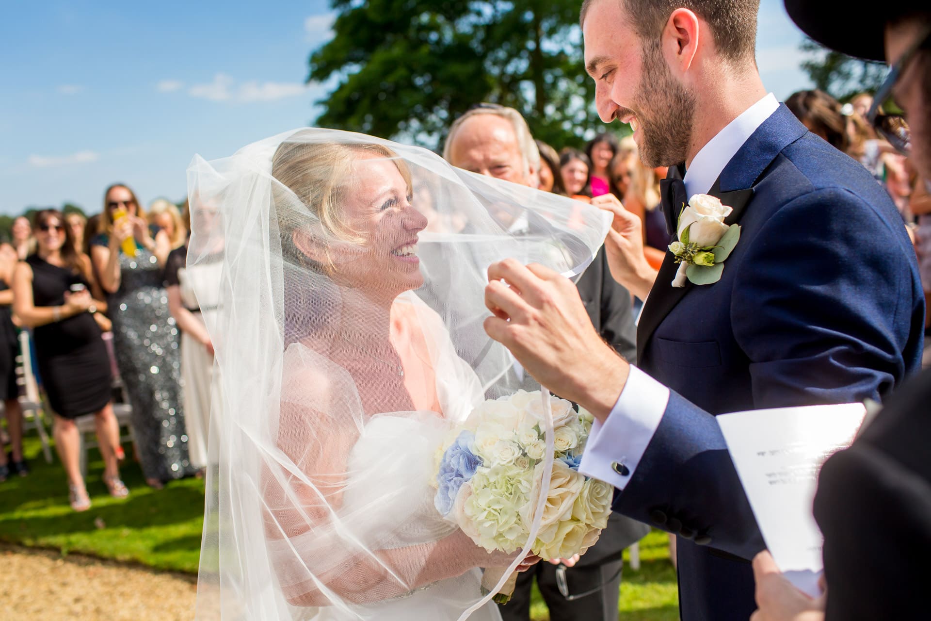 groom lifting bride's veil
