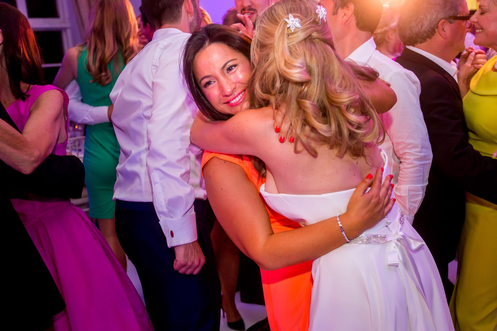 friend hugging the bride