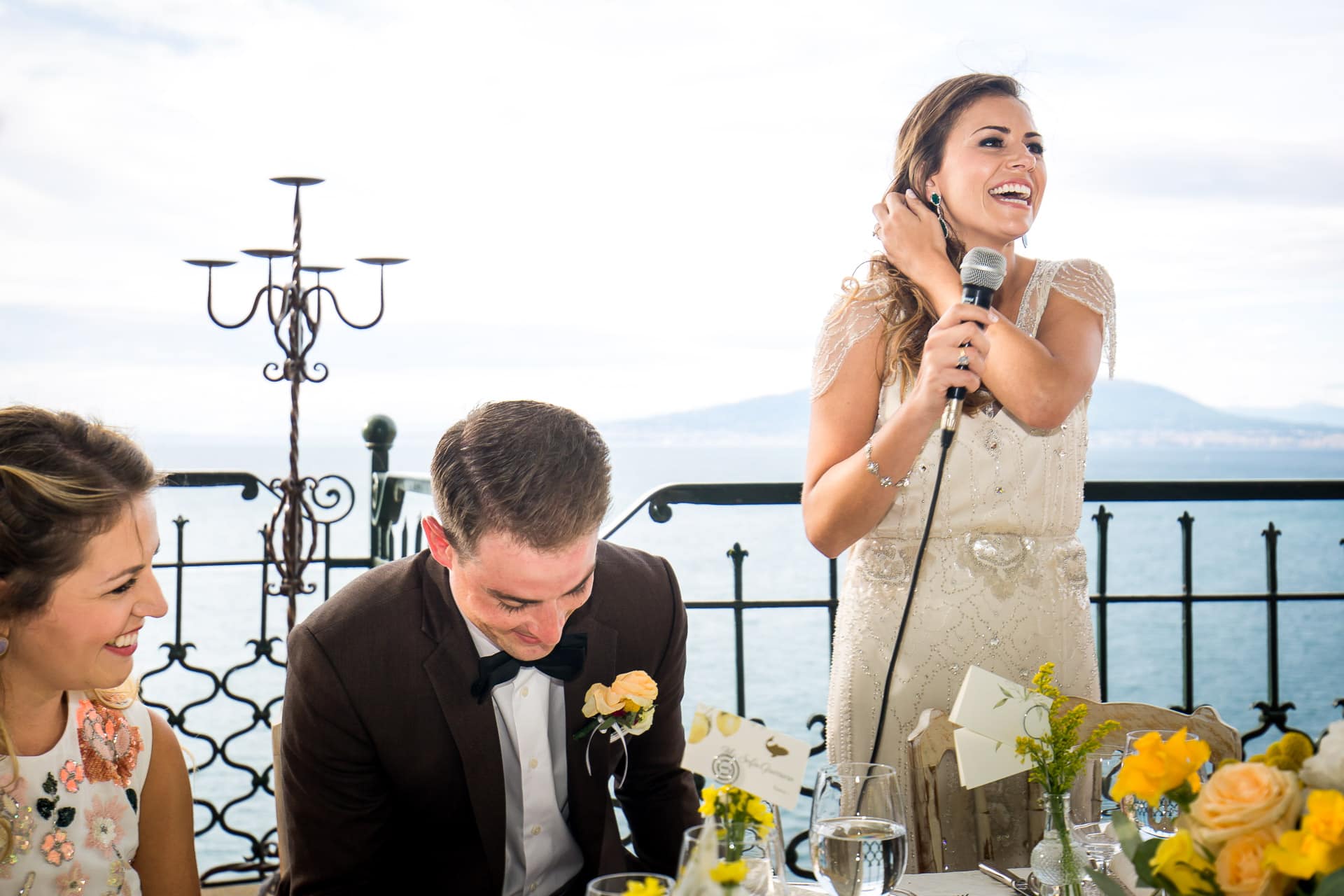 bride giving speech with Bay of Naples behind