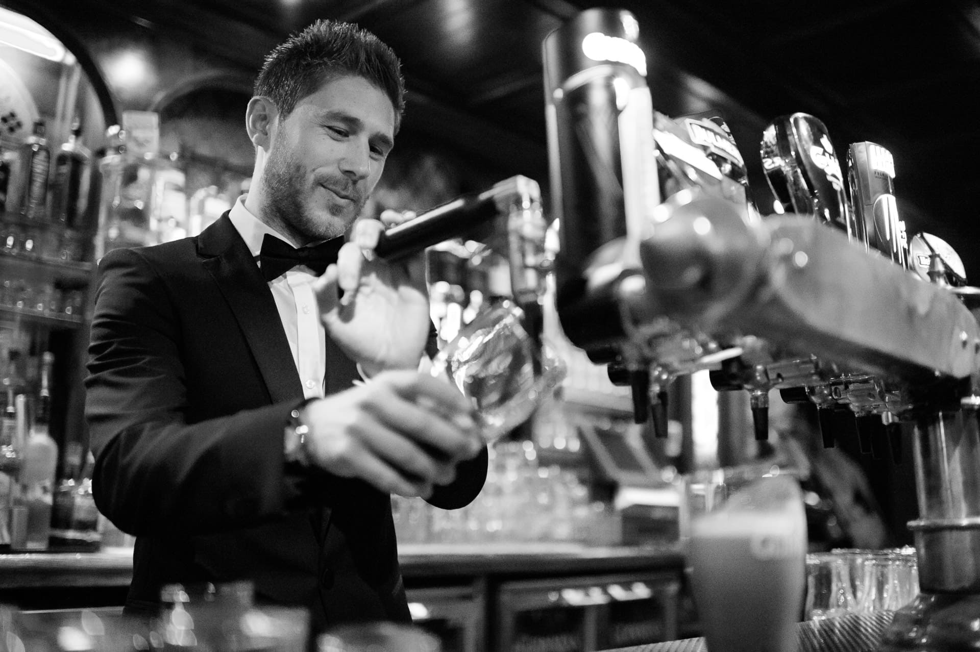 Groom pouring a ping of Guinness
