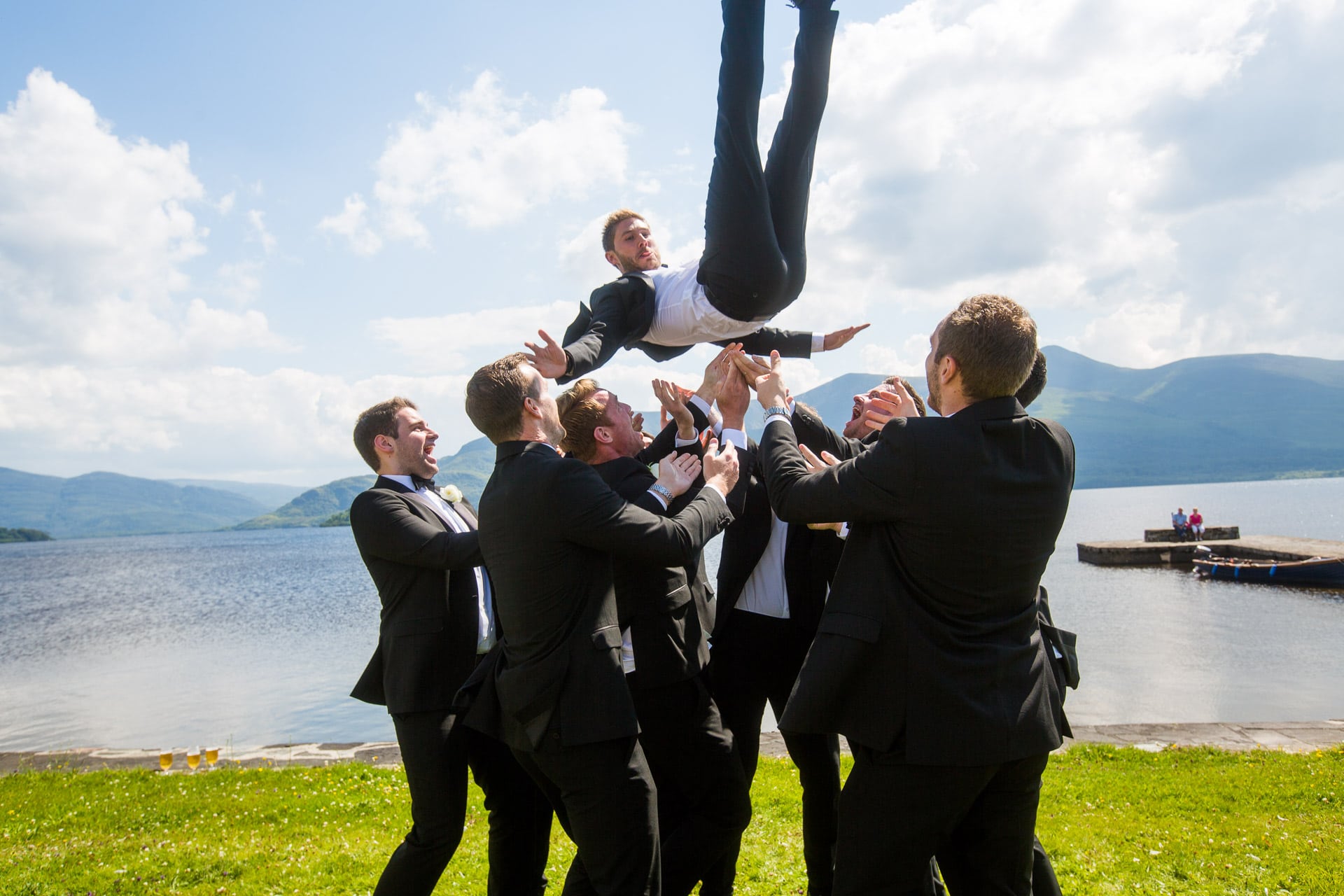 groom being thrown in the air
