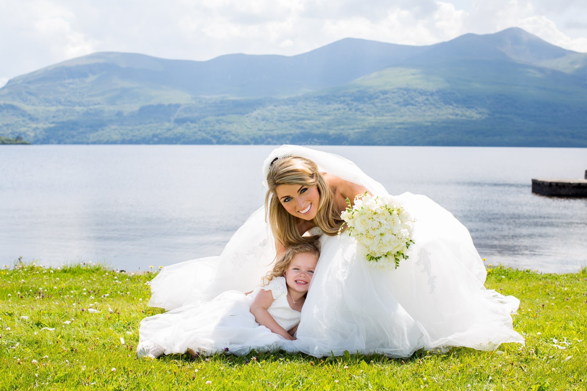 bride and flowergirl by the lake