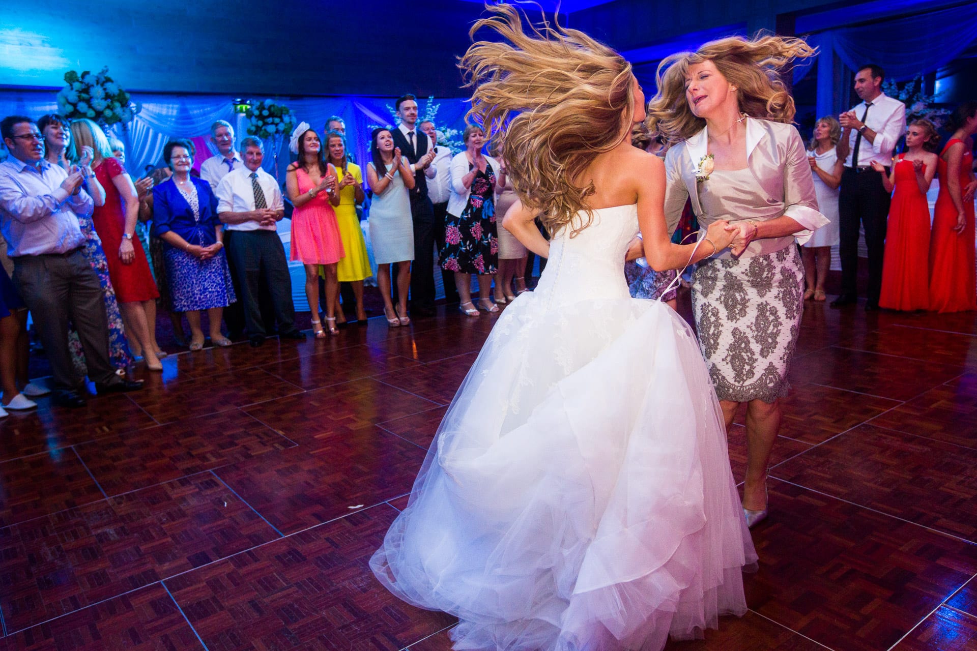 mum and bride dancing wild hair
