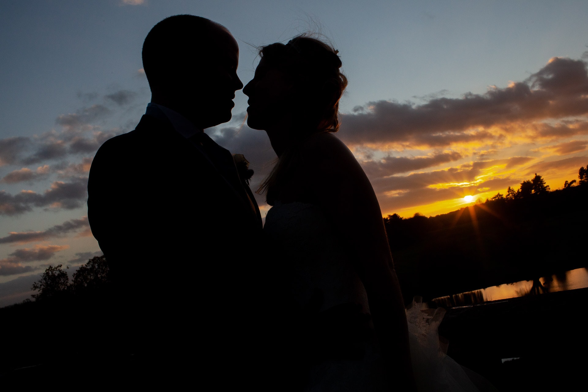 silhouette of wedding couple kissing