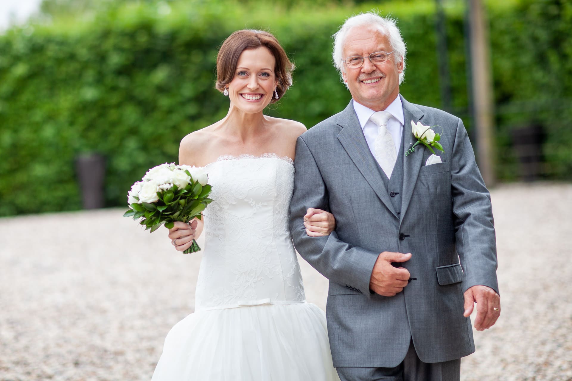 Bride and her dad arm in arm