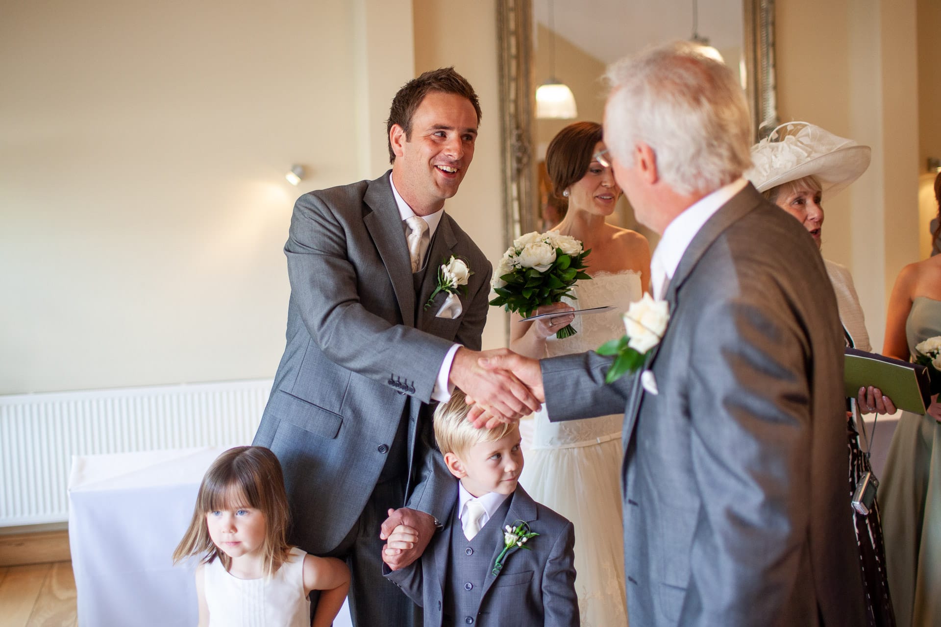 groom shaking hands with dad