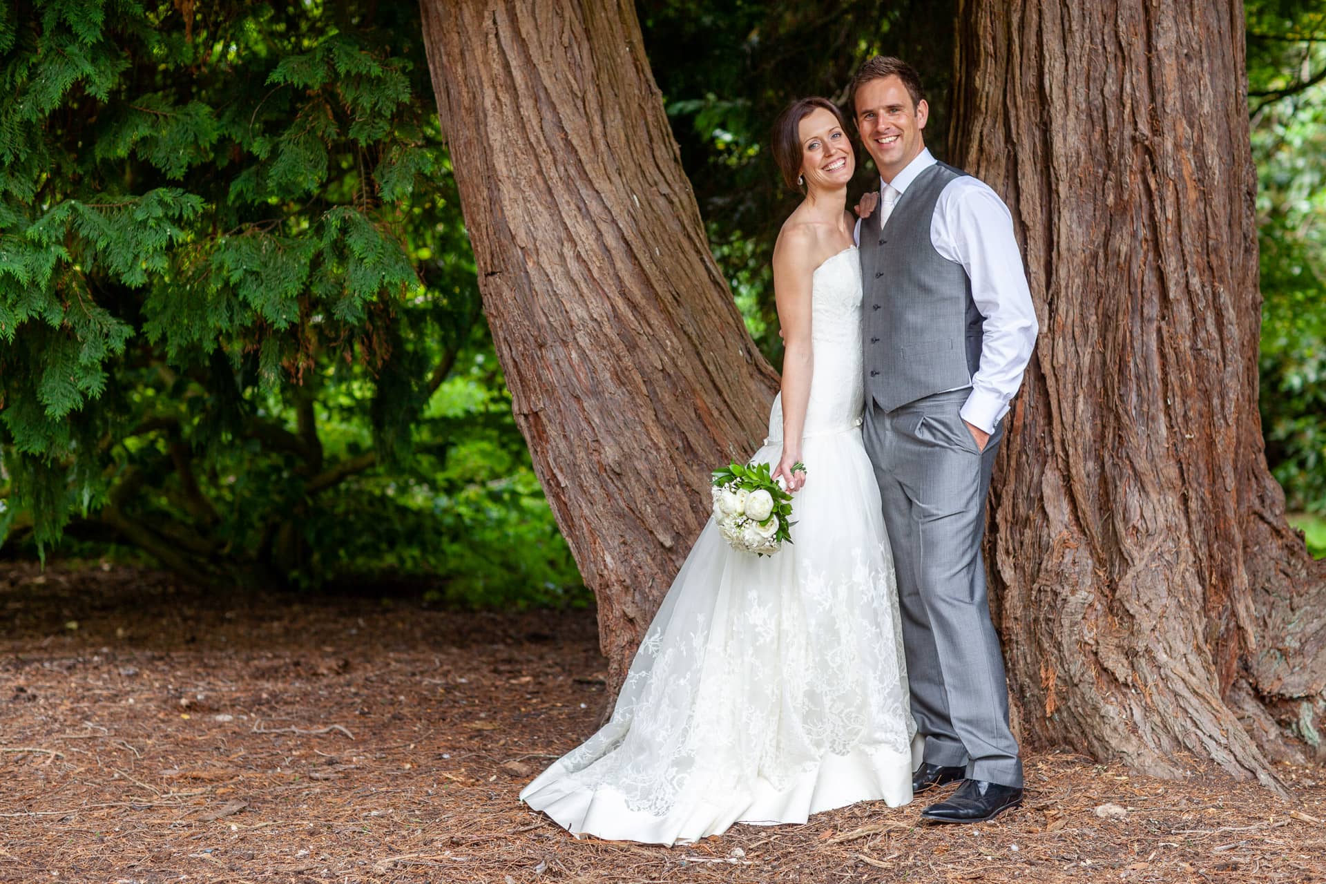 bride and groom by the trees