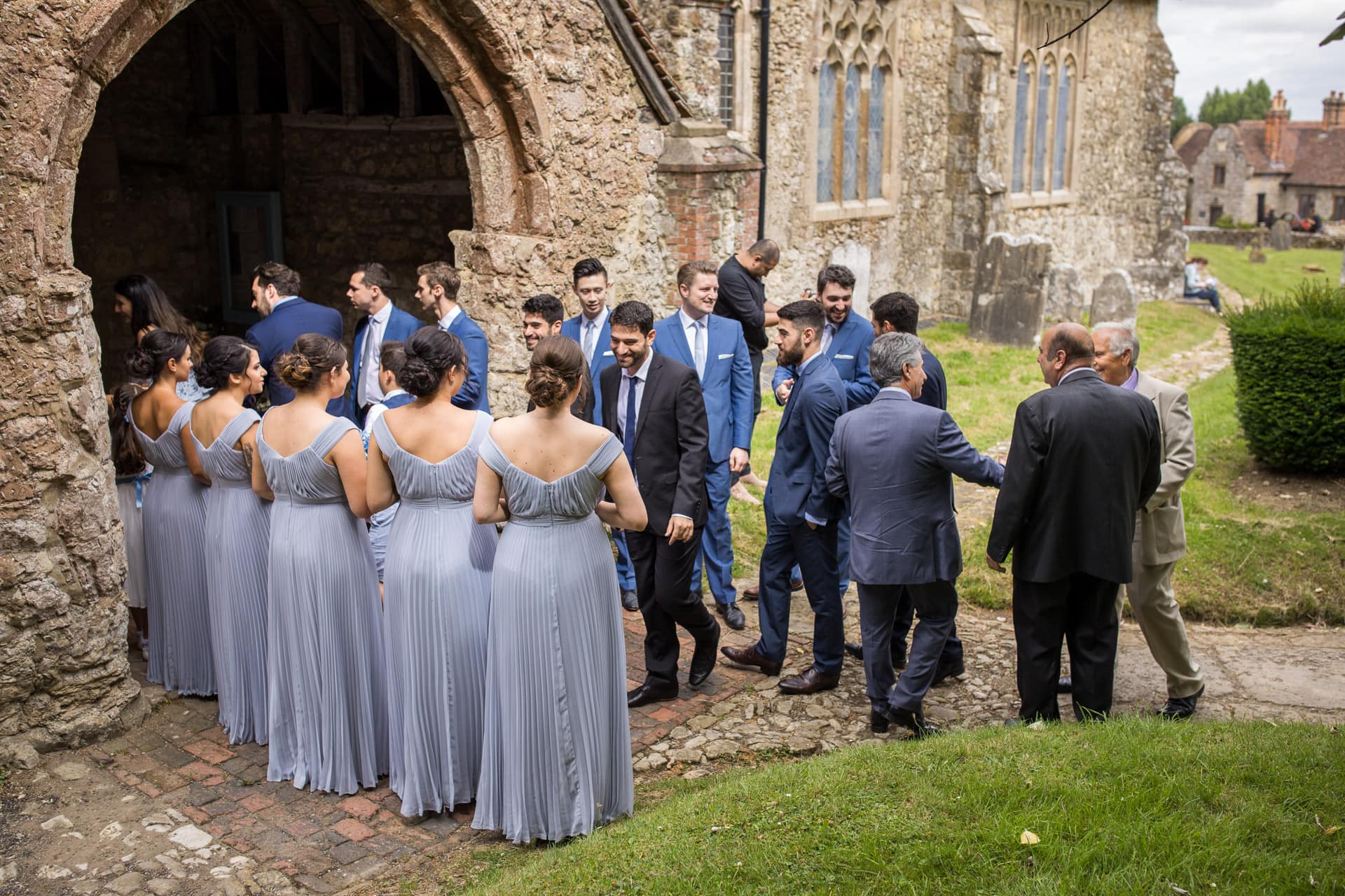 bridesmaids and groomsmen outside church