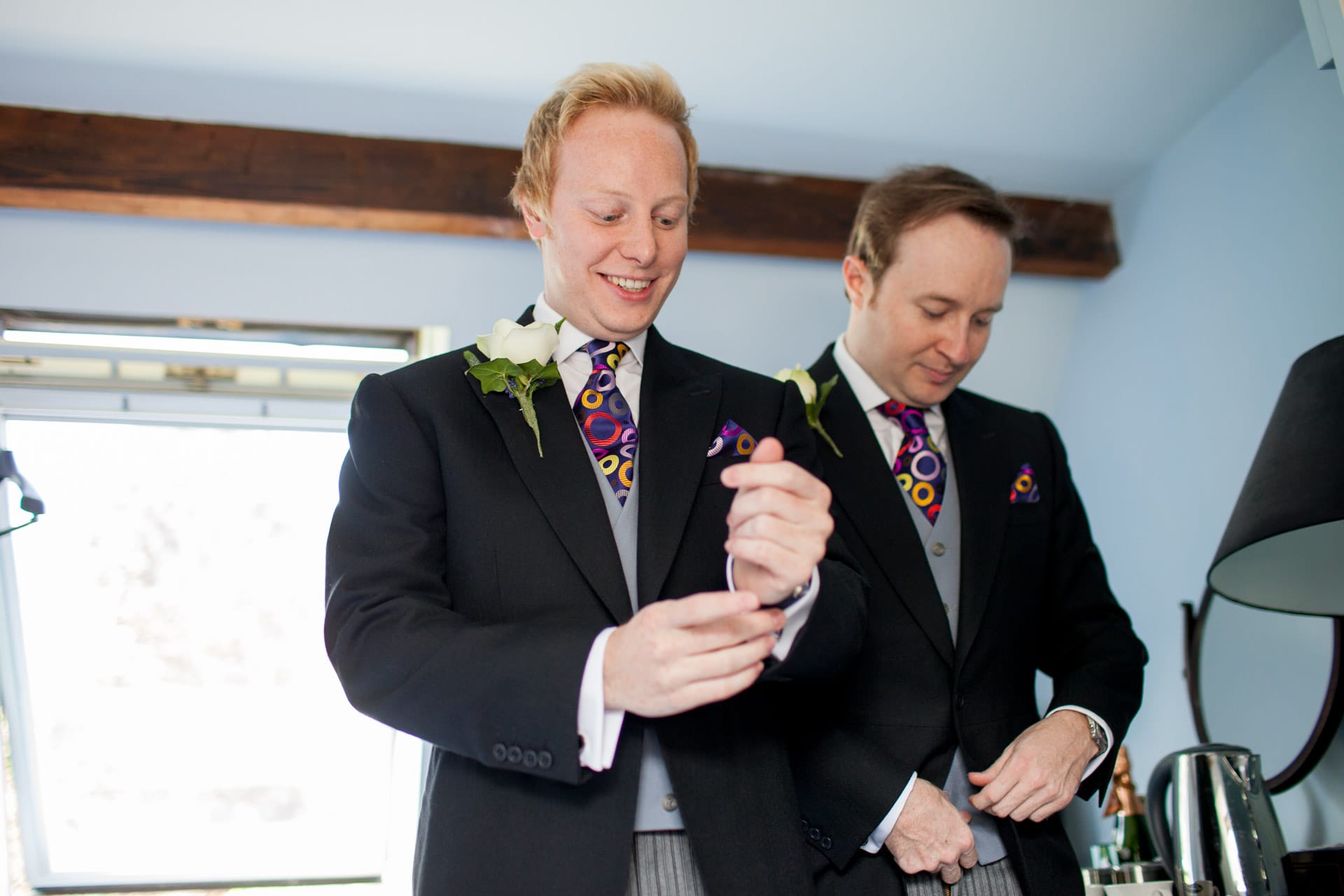groom doing up cufflinks
