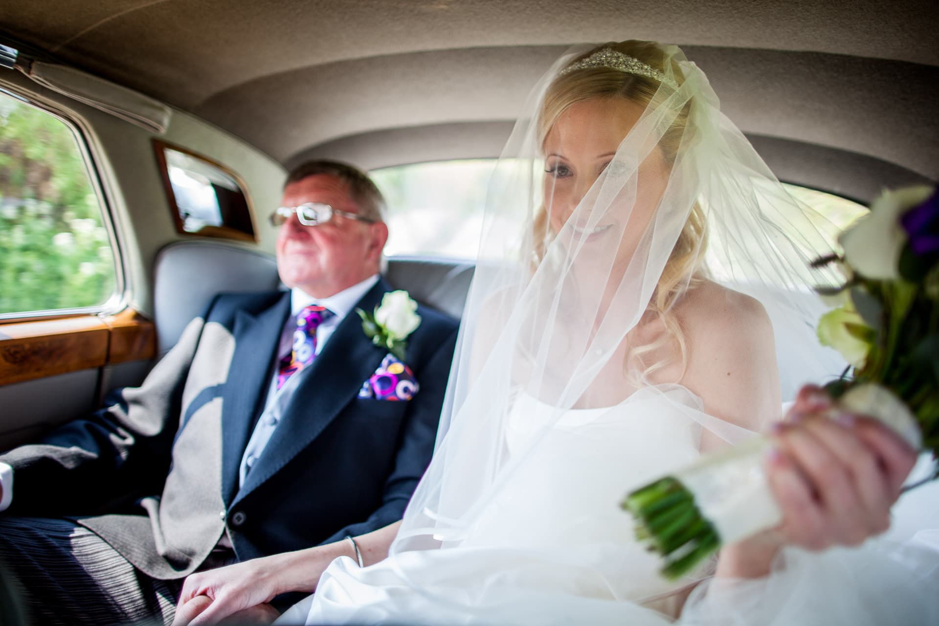 bride and her dad in wedding car