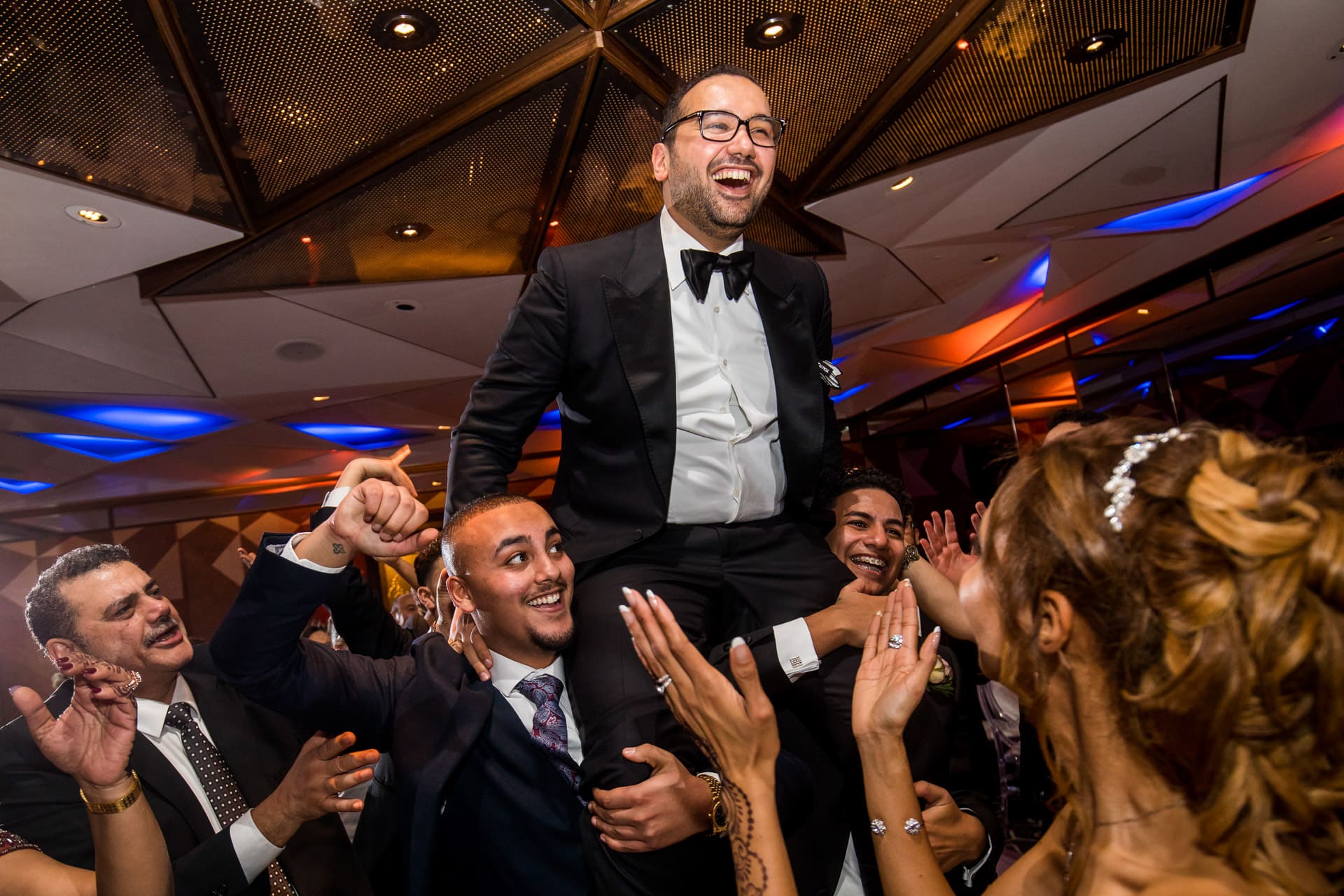 groom being lifted by his friends