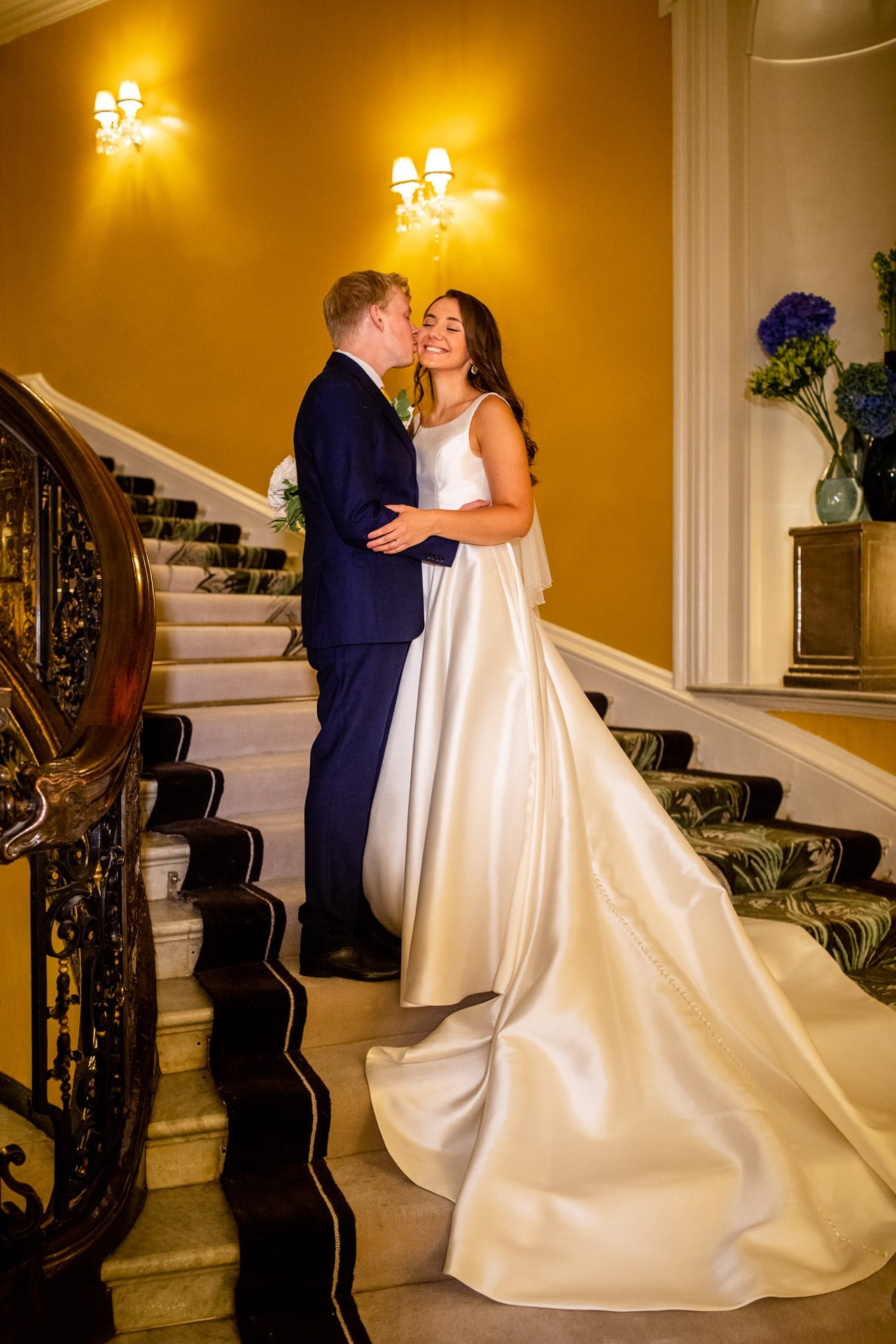bride and groom on Claridges staircase