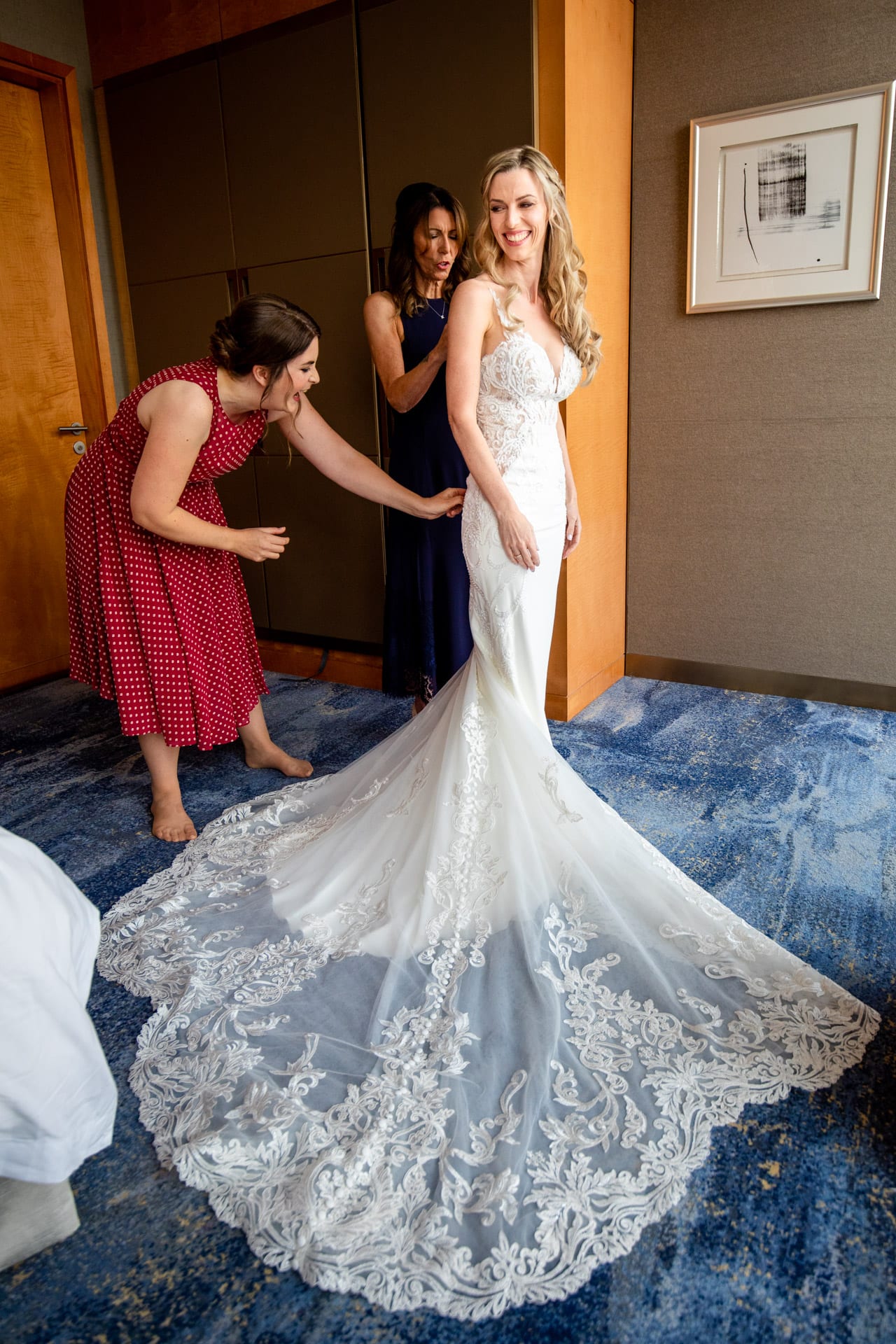 bride putting on a fishtail dress