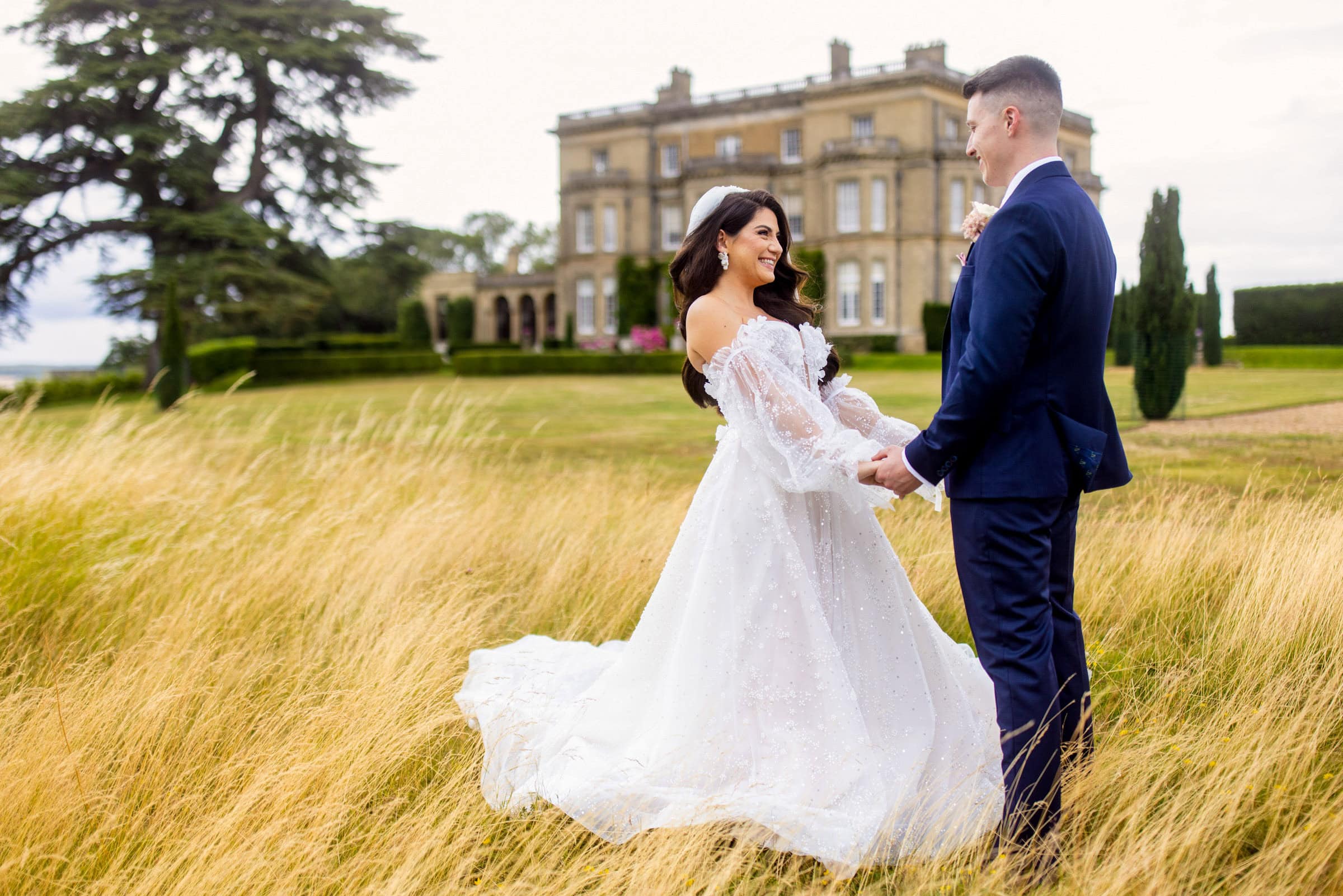 happy couple in the long grass at Hedsor House