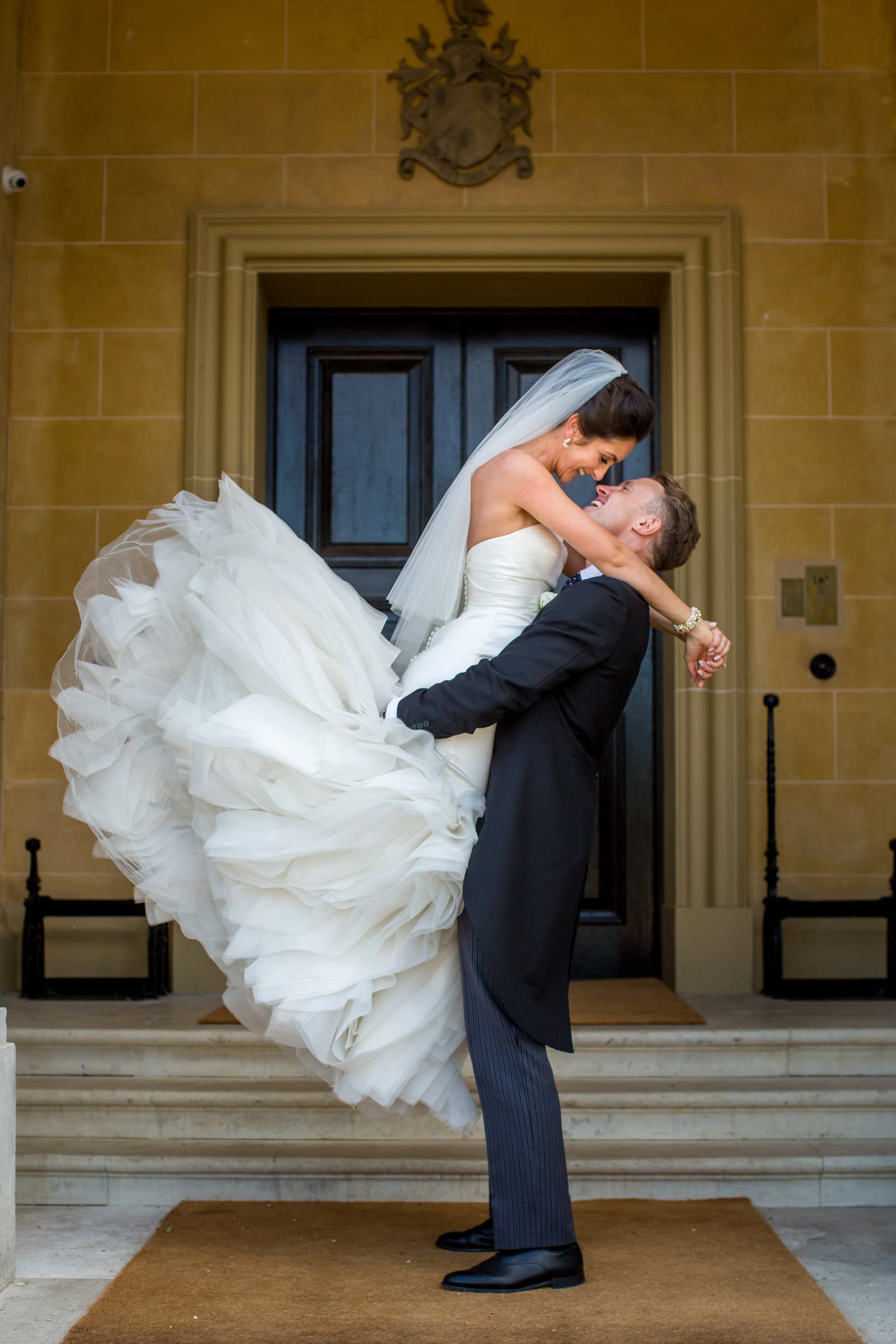 cute shot of groom lifting his bride up