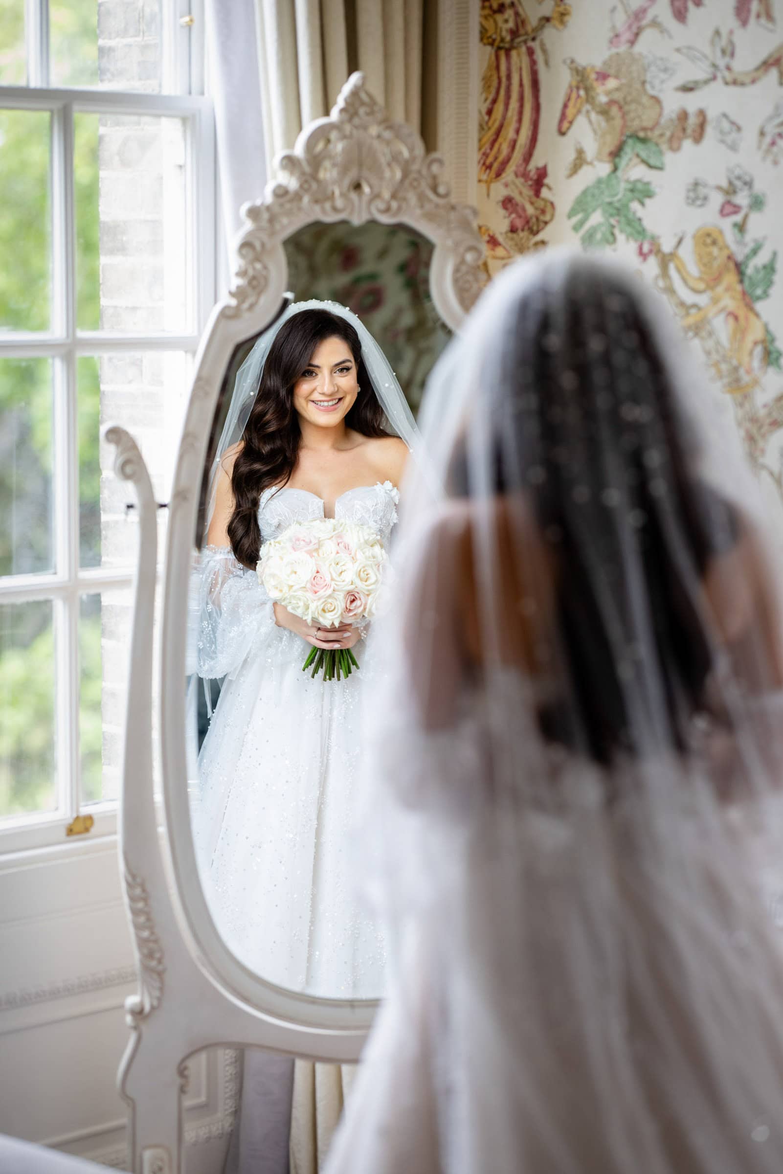 happy bride checking herself in the mirror