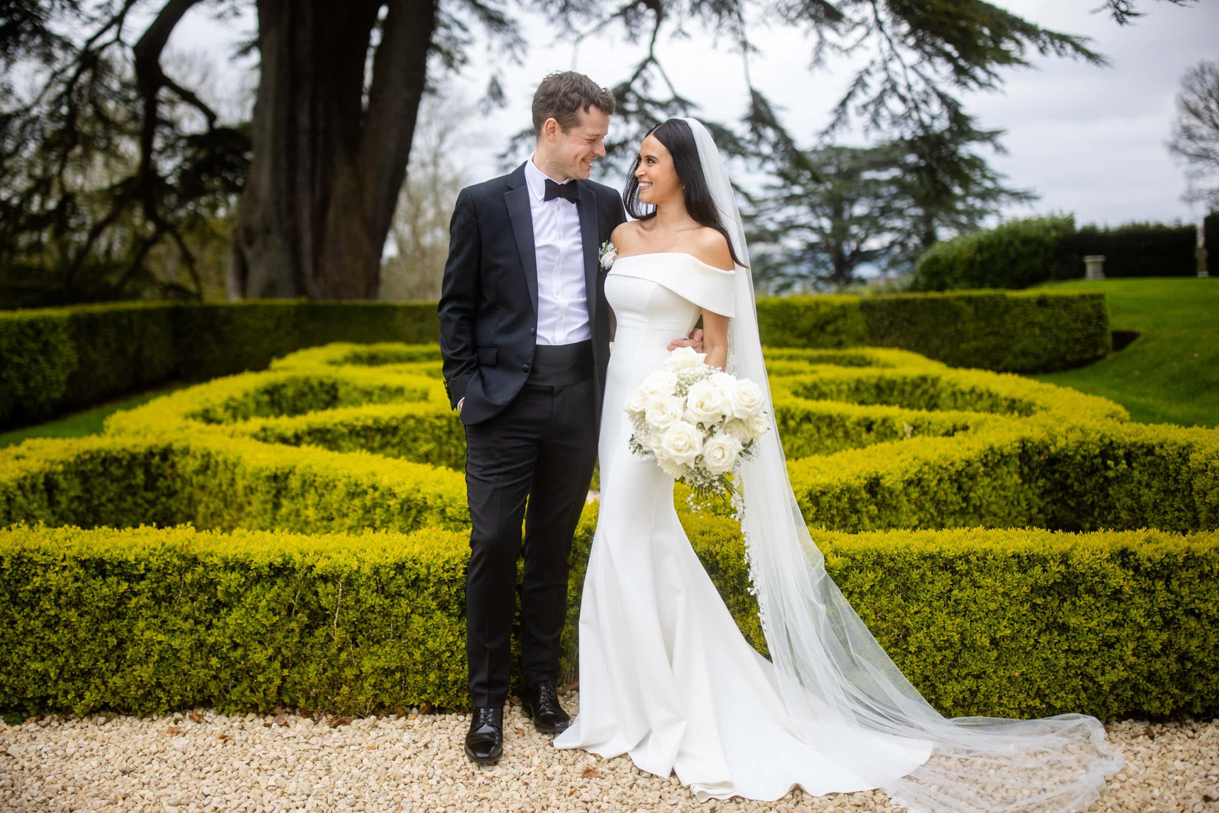 groom in black tie, bride with a long veil
