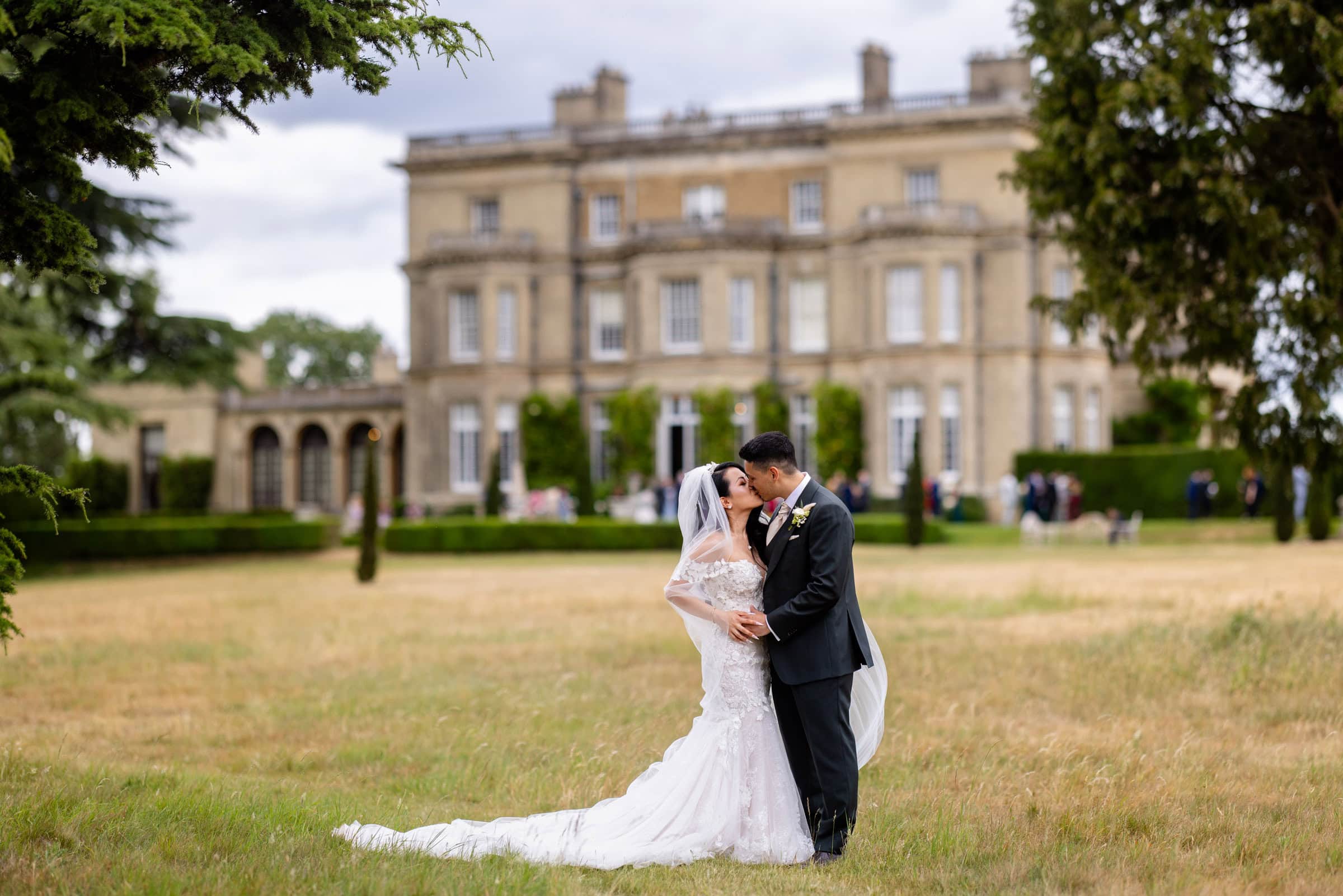 bride and groom with Hedsor House in the background